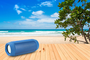 Smart phones and portable speaker on the beach.