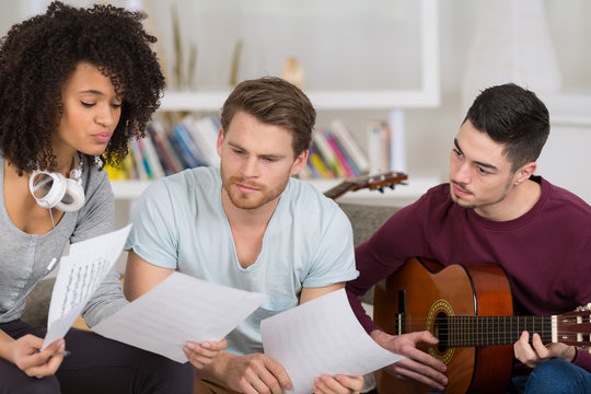 friends playing electric guitar piano and singing