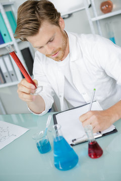 research worker doing experiments with chemical liquid at laboratory
