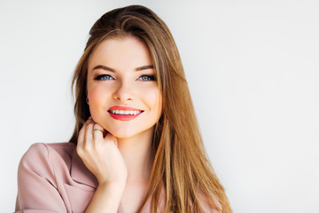 Fototapeta premium Blond gorgeous girl looking into the camera and smiling on white background