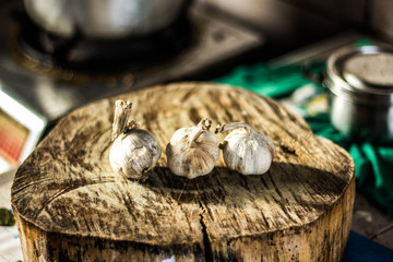 Garlic is on a meat cutting board.