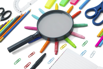 Magnifying glass with school supplies