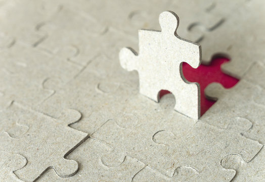 Paper puzzles on a red background. Selective focus.