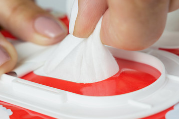 Baby wet wipes in a woman's hand.