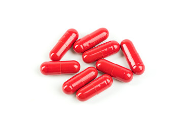 Close up red pill capsules on white background.