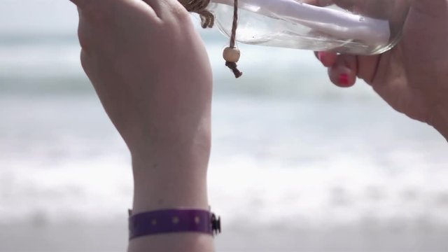 High quality video of looking at message in the bottle on the beach in real 1080p slow motion 250fps.  More videos from this series in my portfolio