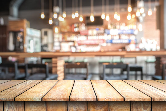 Empty wood top table with space for display product in Blurred cafe background.