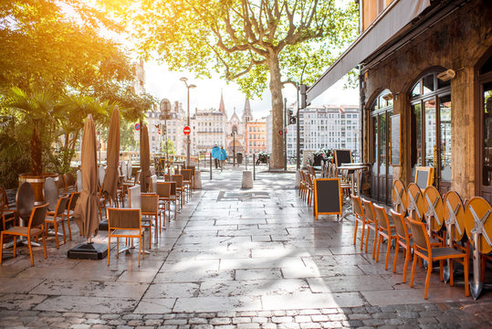 Fototapeta Street view with cafes near the river in the old town in Lyon city