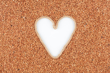 Buckwheat grains and a rope in the shape of a heart with a place for designers.