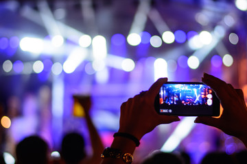 Fan recording concert with mobile phone