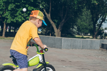 young boy riding strider bike