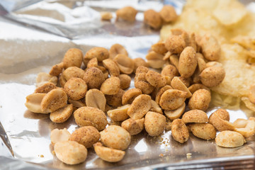 An open packet of peanuts