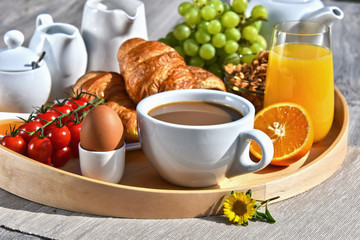 Breakfast served with coffee, juice, croissants and fruits
