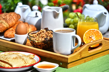 Breakfast served with coffee, juice, croissants and fruits