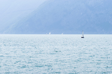 Obraz premium Lake Iseo and sailboats in the small fog, horizontall format