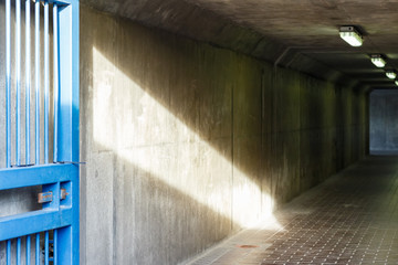 Thames Barrier passageway in London, sunlight cast into a dim and concrete corridor
