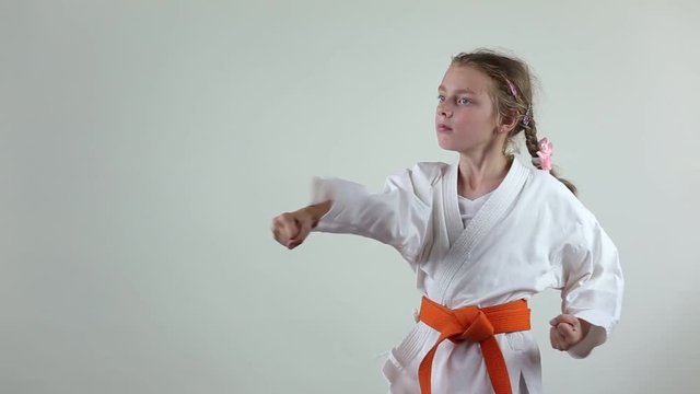 On a white background the girl beats punches