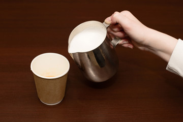 Process of pouring whipped milk from Pitcher