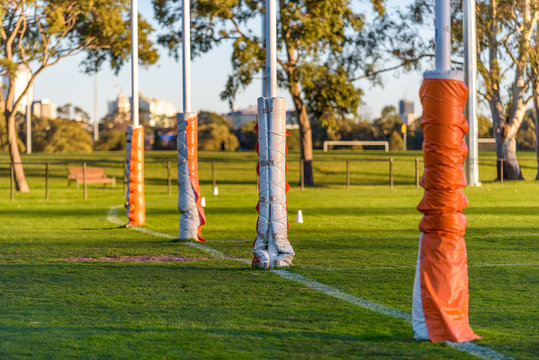 Four Australian football goal posts wrapped with protective padding at a football oval in Carlton, Melbourne, Australia