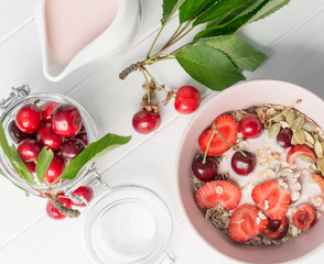 Obraz na płótnie Canvas Healthy breakfast with muesli and cherries, topview