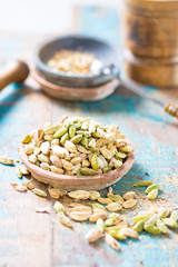 Raw Organic Cardamom Pods on wooden background ready to use