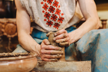 Hands working on pottery wheel