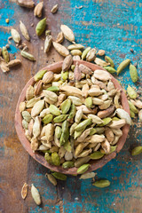 Raw Organic Cardamom Pods on wooden background ready to use