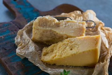 Traditional Italian hard cheese Parmesan and Grana Padano with grater and fresh basil