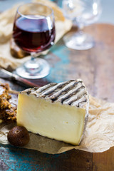 Sweet dessert liqueur wine in glass, hard french cheese Tomme de Montagne and dried figs with figs bread