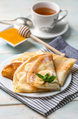 Pancake stack filled with banana slices and honey