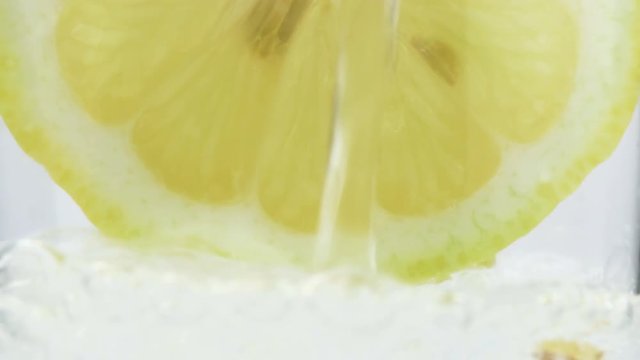 Pouring Carbonated Soda Into Glass With Lemon Slice Closeup Bubbles