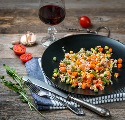 Yummy pilaf with vine and tomatoes on side