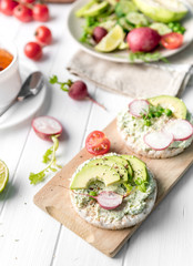 Flatbread with avocado and raddish, cup of tea