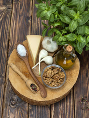 Italian green sauce pesto ingredients on a wooden background. 