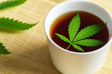 Cannabis herbal tea and marijuana leaves