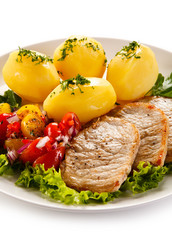 Grilled pork chops, boiled potatoes and vegetable salad 