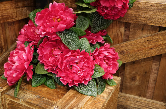Bunch of Vivid Pink Artificial Flowers on Wooden Boxes, with Free Space for Text and Design 