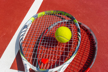 Tennis balls and racket on the grass court