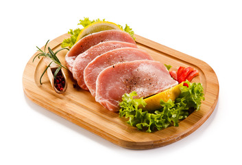 Fresh raw pork on cutting board on white background 