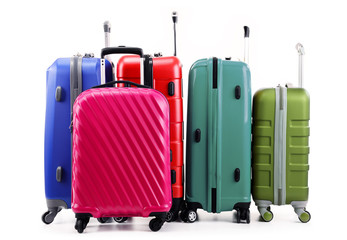 Five plastic suitcases isolated on white