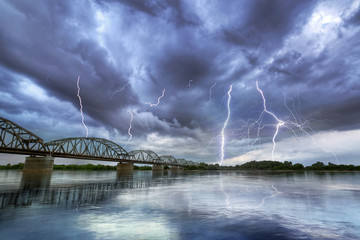 Naklejka na ściany i meble Summer thunderstorm over the Vistula river in Poland