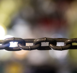 Horizontal gray metal chain large links in close-up tension