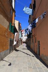 VENICE - APRIL 10, 2017: The view on alley in Venice. Laundry drying in the sun over alley in Venice Italy, on April 10, 2017 in Venice, Italy