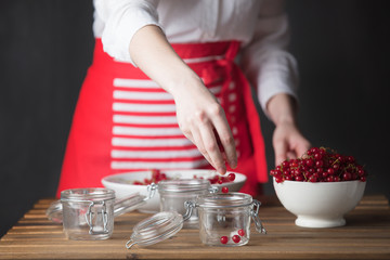Housewife prepare canned head with ribes jam