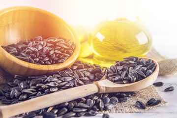 Sunflower seed and oils on wooden table.