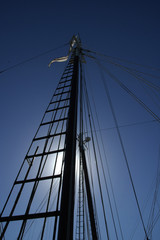 mast up high against sun on sailboat