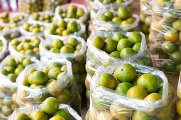 Fresh mandarin orange background on the fruit market showcase.