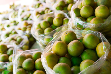 Fresh mandarin orange background on the fruit market showcase.