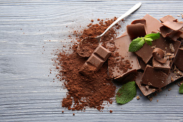 Dark chocolate pieces on wooden table