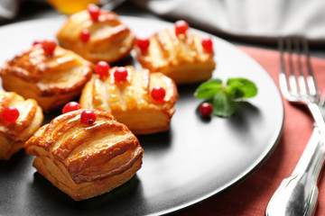 Grey plate with pastries and cranberry, closeup